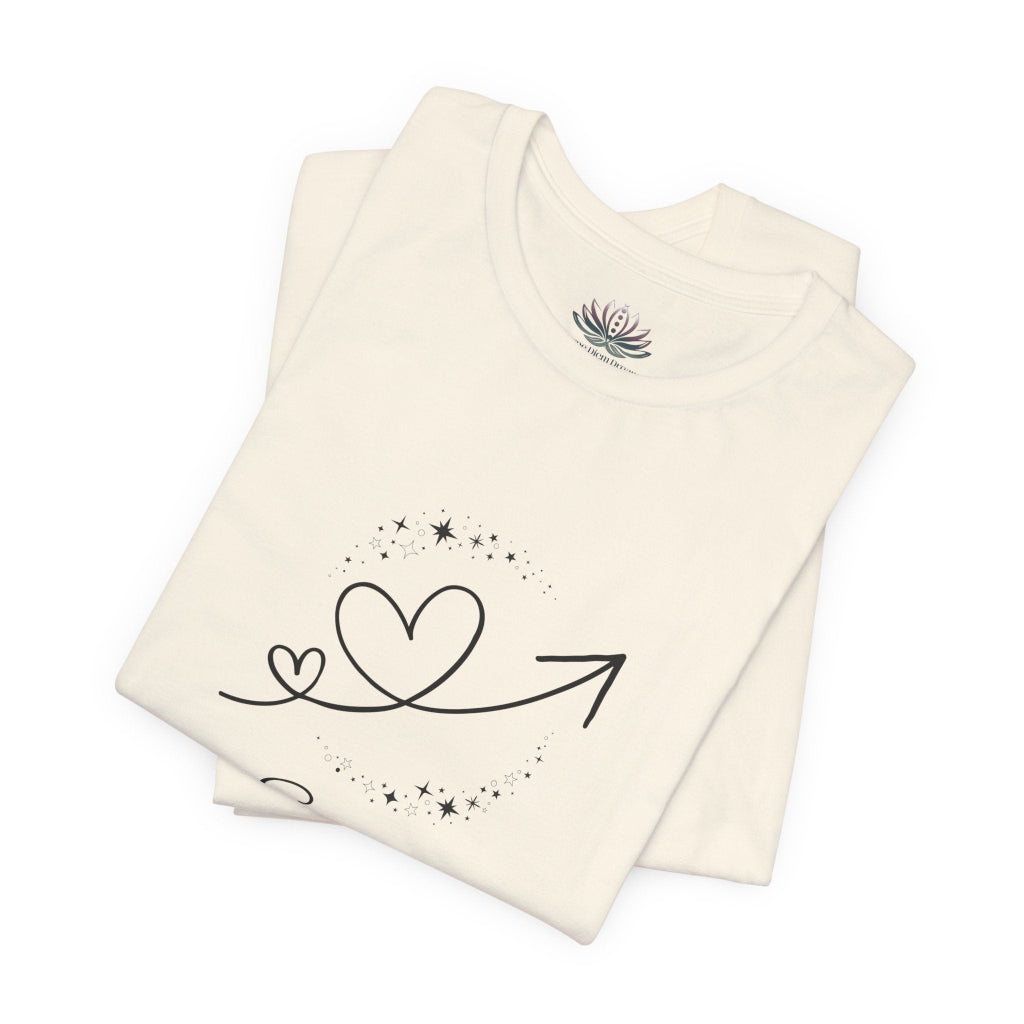Scorpio Rising I Perceive zodiac T-shirt in Natural with black celestial heart and arrow artwork, shown folded in a supplier mockup. — for Carpe Diem Dream