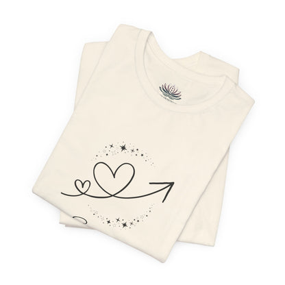 Scorpio Rising I Perceive zodiac T-shirt in Natural with black celestial heart and arrow artwork, shown folded in a supplier mockup. — for Carpe Diem Dream