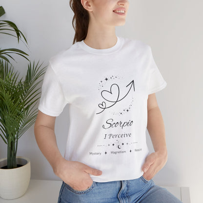 Model wearing a white Scorpio Rising I Perceive zodiac T-shirt with black celestial heart and arrow artwork. — for Carpe Diem Dream