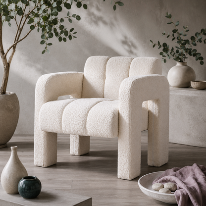 Beige sculpted bouclé upholstered accent chair styled in the Carpe Diem Dream botanical studio with eucalyptus, cool greige flooring, soft stone ceramics, dark teal accents, mauve linen, and diffused natural light. — for Carpe Diem Dream
