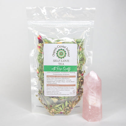 30g Self-Love Crystal Infused Tea featuring organic loose-leaf herbs and Rose Quartz crystal energy, displayed in a clear package beside a polished Rose Quartz point on a clean white background. — for Carpe Diem Dream