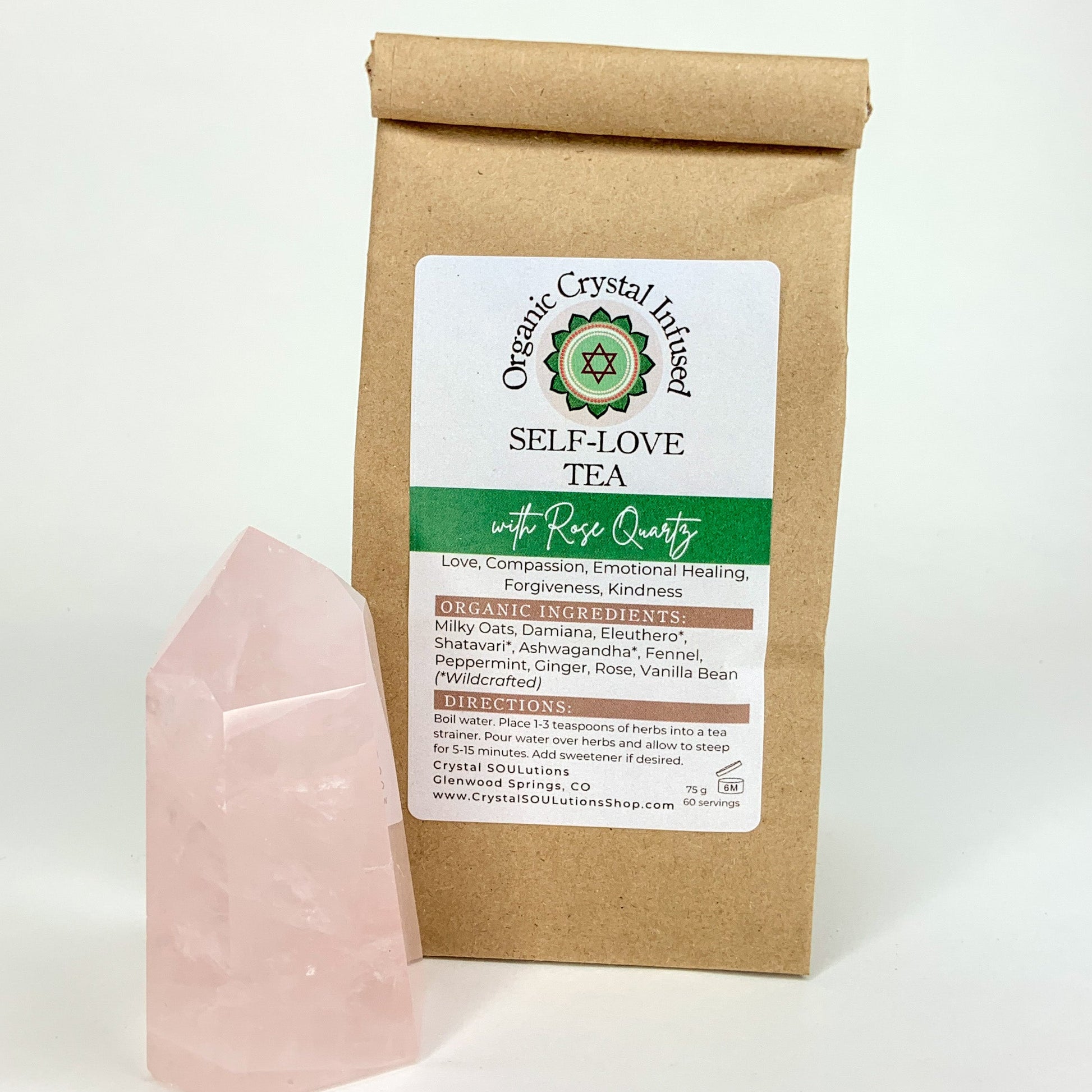 Organic Self-Love Crystal Infused Tea featuring a loose-leaf herbal blend infused with Rose Quartz crystal energy, displayed beside a polished Rose Quartz point on a clean white background. — for Carpe Diem Dream