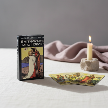 A Smith-Waite Tarot Deck borderless edition box displayed on a soft linen surface with a lit candle and several tarot cards spread in front, creating a calm and mindful reading scene. — for Carpe Diem Dream