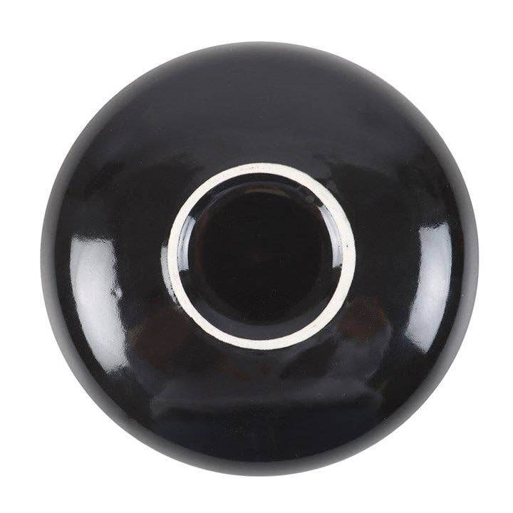 Bottom view of Snake & Flower Celestial Trinket Dish showing glossy black ceramic underside with smooth circular base and reflective finish, photographed against white background for Carpe Diem Dream’s mystical décor collection.