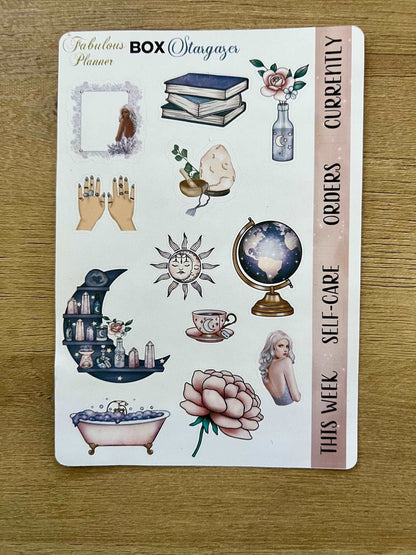 4x6 stargazer planner sticker sheet featuring mystical illustrations including books, crystals, celestial icons, self-care labels, and decorative accents on a wooden background. — for Carpe Diem Dream