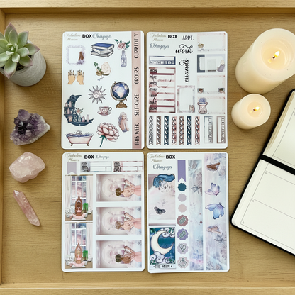 Four 4x6 stargazer planner sticker sheets featuring mystical illustrations, moon phases, crystals, and celestial icons displayed on a wooden tray with candles and crystals. — for Carpe Diem Dream