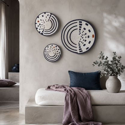 Sunrise Wall Basket set of three handwoven wall baskets styled in a serene sanctuary corner with mauve linen, dark teal pillow, eucalyptus, and soft stone textures — Carpe Diem Dream