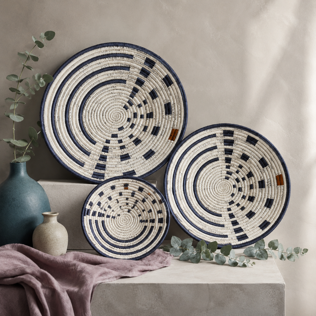 Sunrise Wall Basket handwoven wall basket with navy and natural spiral pattern styled in a cool botanical studio with mauve linen, eucalyptus, and matte ceramics — Carpe Diem Dream