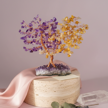 Amethyst and citrine crystal abundance tree displayed on a stone pedestal with soft pink fabric and clear quartz accents against a blush backdrop. — for Carpe Diem Dream