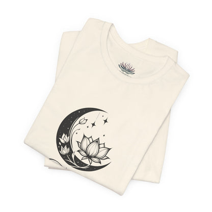 Taurus Moon I Cherish Stability zodiac T-shirt in Natural with black moon-inspired lotus, floral, and celestial artwork, shown folded in a supplier mockup. — for Carpe Diem Dream