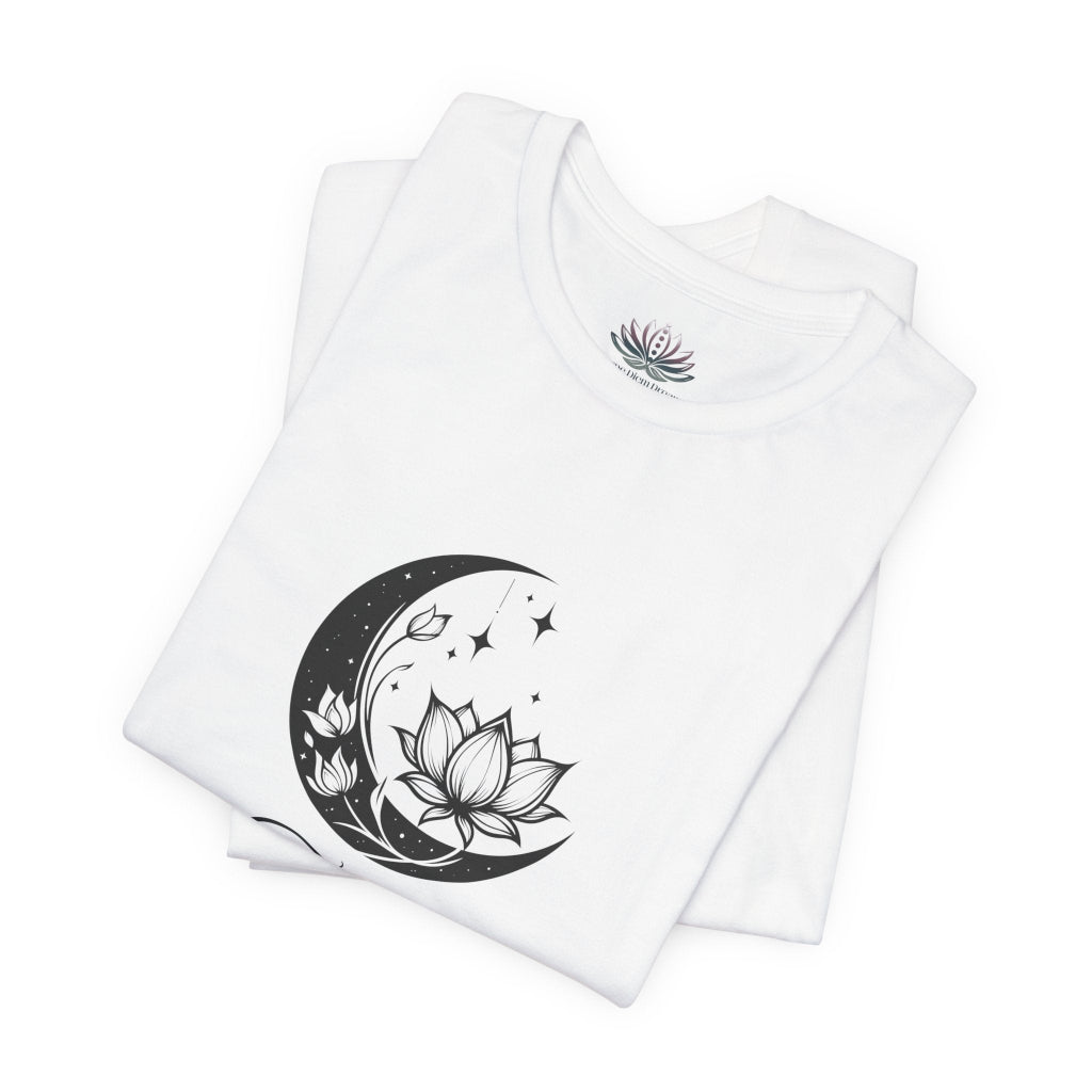 Taurus Moon I Cherish Stability zodiac T-shirt in white with black moon-inspired lotus, floral, and celestial artwork, shown folded in a supplier mockup. — for Carpe Diem Dream