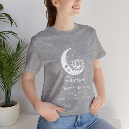Model wearing an Athletic Heather Taurus Moon I Cherish Stability zodiac T-shirt with white moon-inspired lotus, floral, and celestial artwork. — for Carpe Diem Dream