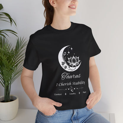 Model wearing a black Taurus Moon I Cherish Stability zodiac T-shirt with white moon-inspired lotus, floral, and celestial artwork. — for Carpe Diem Dream