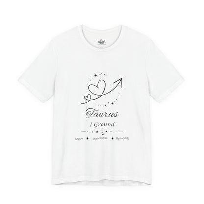 White Taurus Rising I Ground zodiac T-shirt with black celestial heart and arrow artwork, shown in a flat supplier mockup. — for Carpe Diem Dream