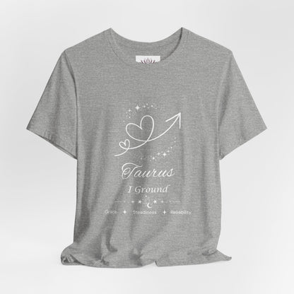 Taurus Rising I Ground zodiac T-shirt in Athletic Heather with white celestial heart and arrow artwork and Grace, Steadiness, Reliability text, shown in a front supplier mockup. — for Carpe Diem Dream