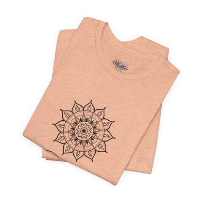 Taurus Sun I Have zodiac T-shirt in heather peach with black sun-inspired mandala artwork, shown folded with Carpe Diem Dream neck label in a supplier mockup. — for Carpe Diem Dream