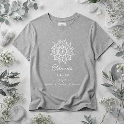 Taurus Sun I Have zodiac T-shirt in athletic heather with white sun-inspired mandala artwork and Stability, Patience, Devotion text, styled in a cool-toned studio botanical flat lay. — for Carpe Diem Dream