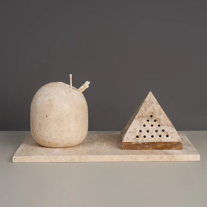 A beige travertine pyramid incense holder displayed beside a stone candle on a matching tray against a neutral background. — for Carpe Diem Dream