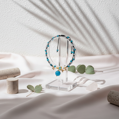 Crystal anklet with pearl, moonstone, and apatite displayed in a botanical studio scene on soft draped fabric with natural lighting and dried greenery. — for Carpe Diem Dream