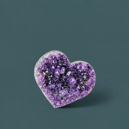 A heart-shaped Uruguayan amethyst cluster with deep violet crystal points displayed against a muted teal textured background. — for Carpe Diem Dream