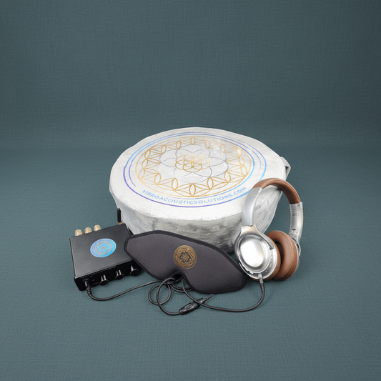 A vibroacoustic meditation cushion bundle featuring a round zafu cushion with a gold lotus mandala, a compact black amplifier, over-ear headphones, and a satin eye mask arranged on a muted sage background. — for Carpe Diem Dream