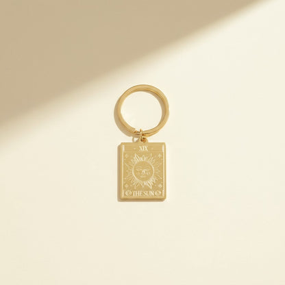 The Sun keyring from the Vintage Tarot Card Keyring collection, featuring an engraved gold design on a neutral background, styled for Carpe Diem Dream.
