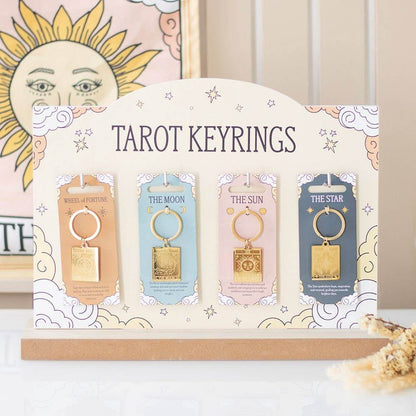 Display of Vintage Tarot Card Keyrings featuring The Sun, The Moon, The Wheel of Fortune, and The Star designs in a celestial-themed holder with a neutral background, styled for Carpe Diem Dream.