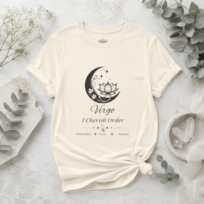 Virgo Moon I Cherish Order zodiac T-shirt in Natural with black moon-inspired lotus, floral, and celestial artwork and Practicality, Care, Routine text, styled in a cool-toned studio botanical flat lay. — for Carpe Diem Dream