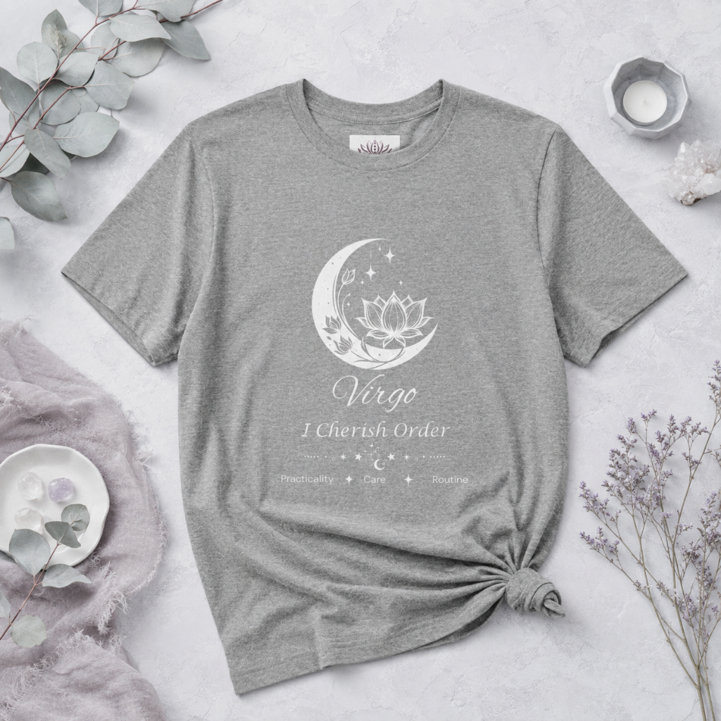 Virgo Moon I Cherish Order zodiac T-shirt in Athletic Heather with white moon-inspired lotus, floral, and celestial artwork and Practicality, Care, Routine text, styled in a cool-toned studio botanical flat lay with eucalyptus, lavender, crystals, and ceramic accents. — for Carpe Diem Dream