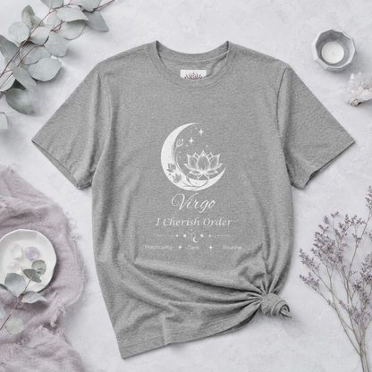 Virgo Moon I Cherish Order zodiac T-shirt in Athletic Heather with white moon-inspired lotus, floral, and celestial artwork and Practicality, Care, Routine text, styled in a cool-toned studio botanical flat lay with eucalyptus, lavender, crystals, and ceramic accents. — for Carpe Diem Dream