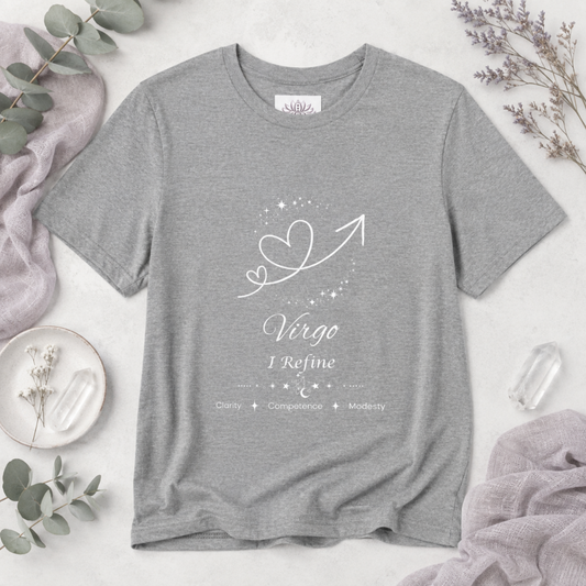 Virgo Rising I Refine zodiac T-shirt in Athletic Heather with white celestial heart and arrow artwork and Clarity, Competence, Modesty text, styled in a cool-toned studio botanical flat lay. — for Carpe Diem Dream