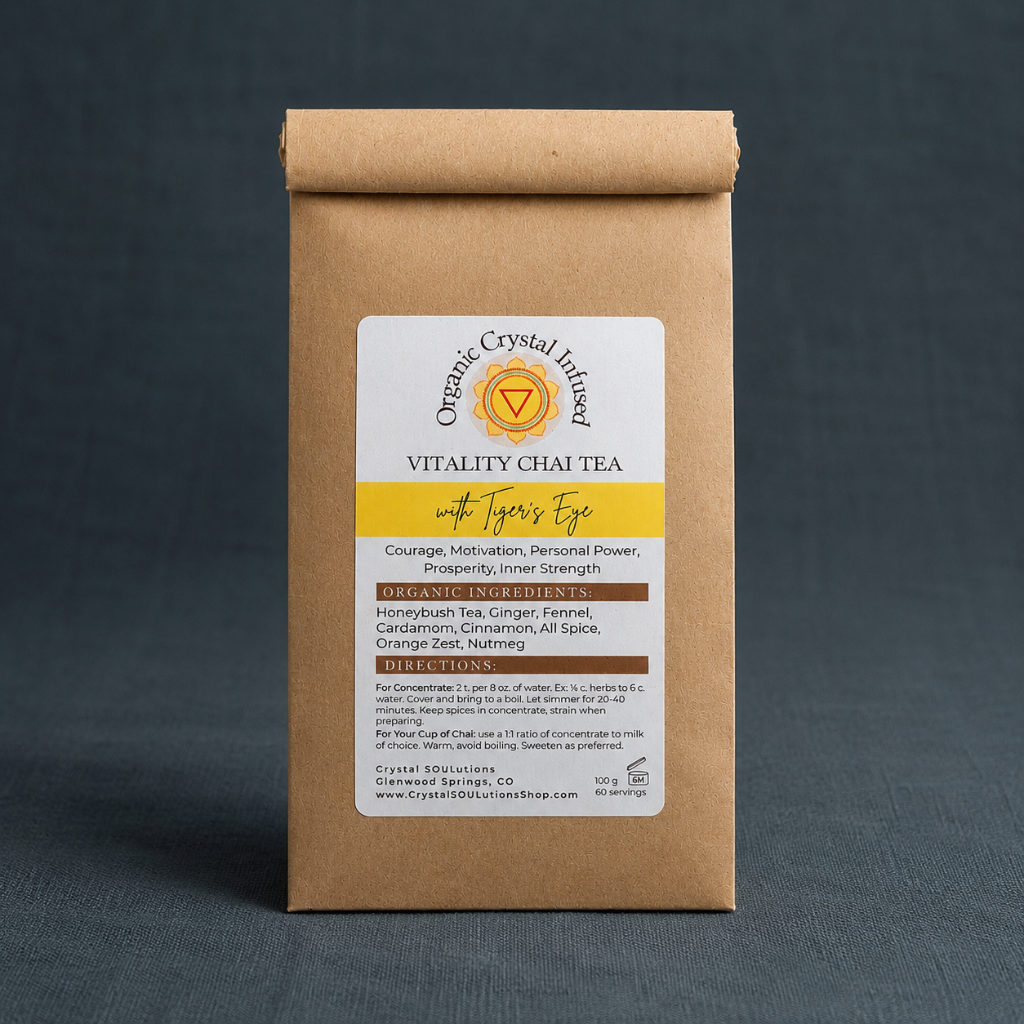 Vitality Chai Tea – Organic Crystal-Infused Tea with Tiger's Eye in the authentic 100 g kraft paper package, photographed dark teal textured linen background with cool diffused lighting, soft contact shadows, and no props. — for Carpe Diem Dream