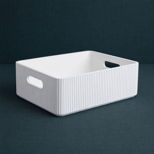 White wooden ribbed storage bin with fluted exterior and cutout handles styled on a dark teal linen backdrop. — for Carpe Diem Dream