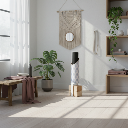 Light blue and white patterned yoga storage tube holding a black yoga mat with a white block stand and wooden yoga blocks in a bright wellness room with plants, shelving, a bench, and a mauve throw. — for Carpe Diem Dream