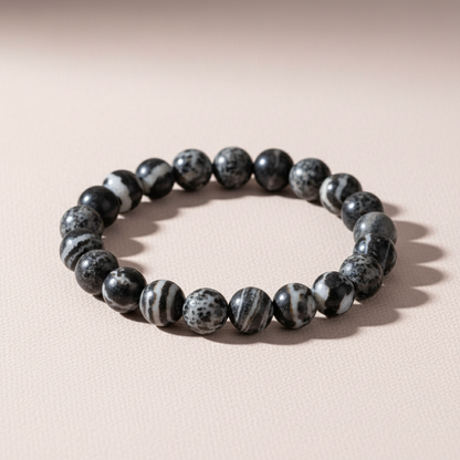 Zebra Jasper beaded bracelet displayed in a perfect circle on soft blush surface with natural light and gentle shadow. — for Carpe Diem Dream