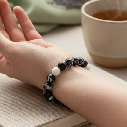 Zebra Jasper beaded bracelet worn on wrist beside steaming mug and soft fabric surface with gentle shadow. — for Carpe Diem Dream