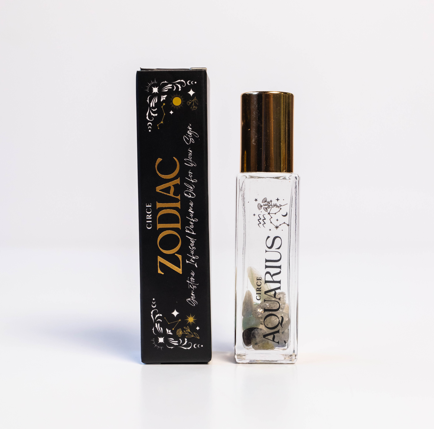 Aquarius zodiac gemstone perfume oil rollerball with labradorite crystals displayed beside zodiac packaging on a white background. — for Carpe Diem Dream