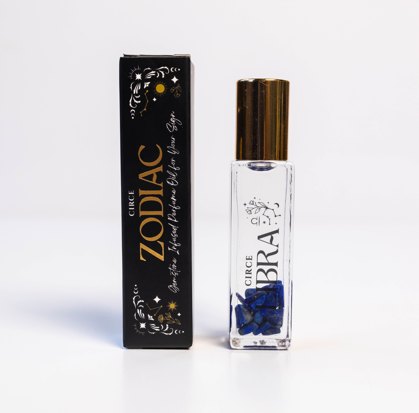 Libra zodiac gemstone perfume oil rollerball with lapis lazuli crystals displayed beside zodiac packaging on a white background. — for Carpe Diem Dream