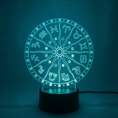 Illuminated zodiac wheel LED night light with etched astrological symbols glowing blue on a black base. — for Carpe Diem Dream
